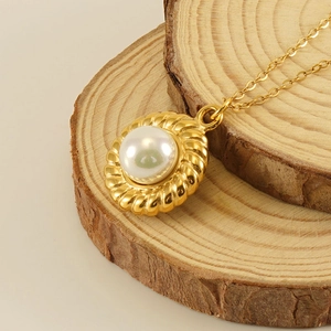 18k gold plated sunflower pearl necklace on minimalist wooden display stand