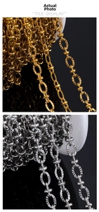 Macro detail of gold and silver stainless steel oval link chains with engraved texture
