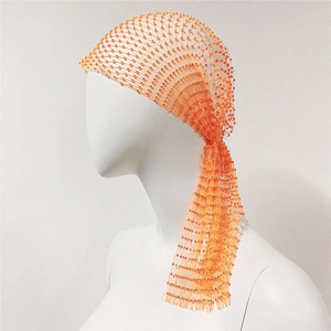 Detail of orange beaded mesh headpiece with long fringe for party and festival