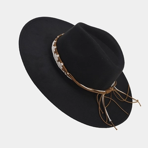 Close-up of black wide brim fedora with ethnic woven band and brown fringe detail