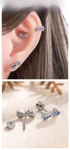 Detailed view of bow-shaped zircon ear studs with screw back in various colors