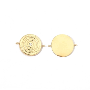 Detail of golden stainless steel round jewelry connectors with textured crystal inlay