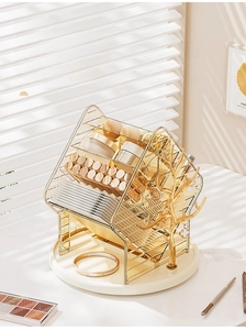 Close-up of golden house-shaped rotating makeup organizer with jewelry hooks