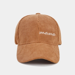Detail of mama embroidery on brown corduroy baseball cap with soft ribbed texture