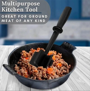 Multipurpose black meat chopper tool mashing ground beef in a cast iron skillet