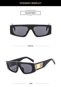 Detail view of retro wide-frame sunglasses with striped metal temple and black finish