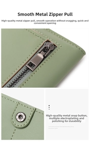 Détail du zip fluide et bouton pression étoile sur ce long portefeuille RFID vert