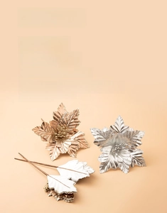 Macro detail of metallic glitter Christmas leaves in gold and silver for DIY decor
