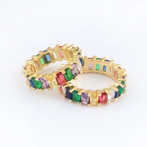 Detailed close-up of bohemian gold rings with vibrant colorful zircon stones