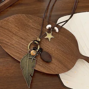 Bohemian vintage long necklace with bronze leaf, starfish and wood beads on brown rope