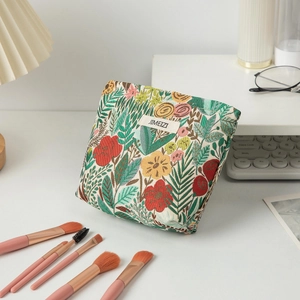 Floral embroidery makeup bag detail with colorful botanical patterns on canvas surface