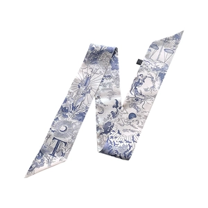 Detailed close-up of white and blue Toile de Jouy silk scarf with delicate floral print