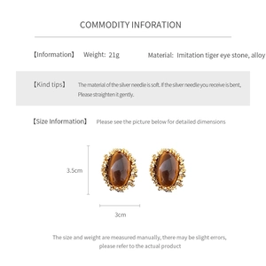 Detail view of vintage oval tiger eye stone earrings with size and weight specifications