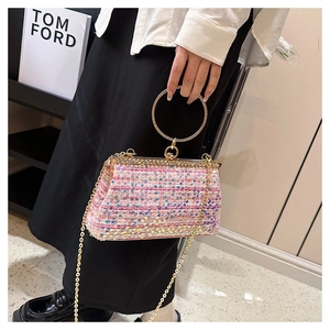 Detail of evening clutch featuring sequins, rhinestone ring handle and gold chain strap