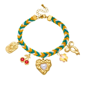 Colorful woven rope bracelet with cherry, pearl heart, and crystal bow charms on white