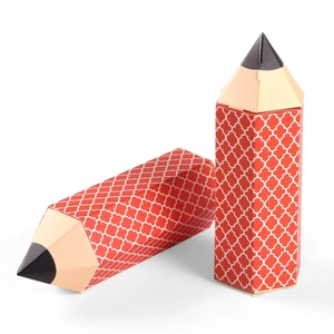 Macro view of pencil-shaped candy gift boxes with red clover pattern on a white background