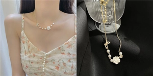 Detail of gold necklace featuring white rose pendant, pearl accents and bow charm