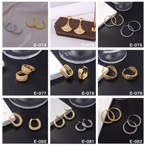 Collection of nine luxury gold and silver hoop earrings featuring zircons and textures