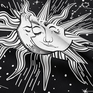 Close-up of bohemian tapestry showing sun and moon print on woven fabric texture