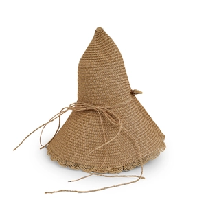 Detailed macro view of wide brim straw sun hat with intricate scalloped lace edges