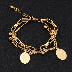 Close-up of double-layer 18k gold Virgin Mary bracelet with bead details and engraving