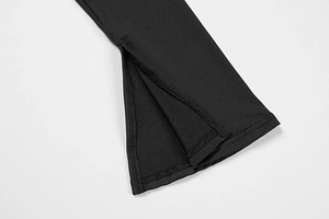 Close-up detail of the black dress featuring a side split hem and fine stitching finish