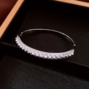 Detail view of silver studded bangle with crystals in a black jewelry display box