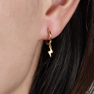 Close-up of S925 silver lightning bolt earring with pavé zircon on a female model's ear