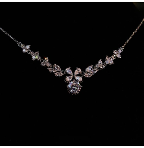Macro view of crystal flower pendant with pavé-set zircons on elegant silver chain