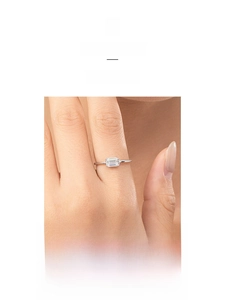 Macro shot of minimalist silver ring featuring a rectangular step-cut cubic zirconia stone