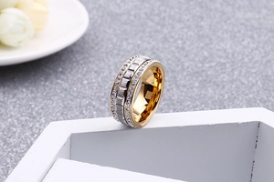 Detail shot of a two-tone rose gold and silver stainless steel ring with pavé set crystals