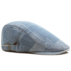 Detail of vintage denim newsboy cap with metal buckle and blue patchwork pattern