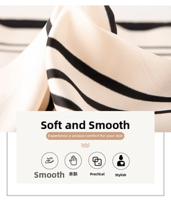 Close-up of black and white striped silk scarf showing smooth texture and fine twill weave