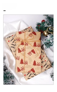 Detail of kraft Christmas wrapping paper with reindeer patterns and rustic hemp rope
