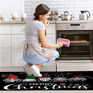 Close-up of long Christmas kitchen runner rug with gnome design and Merry Christmas text