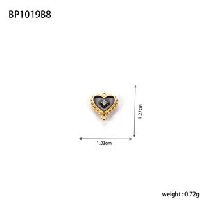 Detail of heart pendant with black enamel and zircon inlay showing 1.27cm dimensions