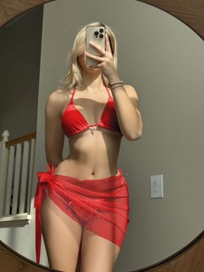 Detailed macro view of the vibrant red mesh texture and delicate white beads on the bikini set