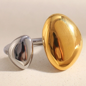 Detailed shot of two-tone irregular drop ring with 18K gold and silver polished finish