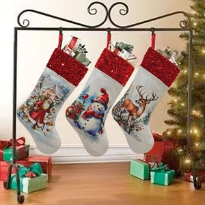 Detailed view of three Christmas stockings with sequins, Santa, snowman and reindeer designs
