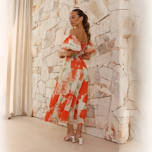 Detail of smocked off-shoulder bodice and puffed sleeves on floral tiered maxi dress