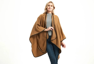 Detail showing elegant black leather trim on camel brown sleeveless wrap cape shawl