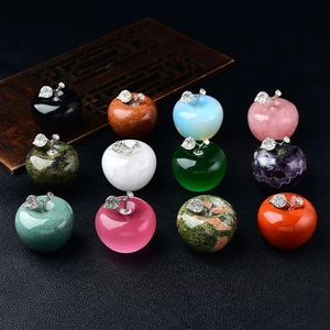 Variety of colorful natural crystal apple stones with silver leaves for home decor