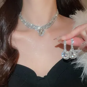 Vintage silver-tone teardrop pendant necklace and long earrings set with rhinestones