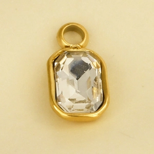Macro detail of a 304 stainless steel rectangular crystal pendant with a gold finish