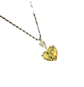 Elegant silver necklace featuring a heart-shaped yellow gemstone and pear-cut zircon pendant