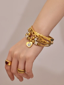 Vista de detalle del set de pulseras de acero dorado con circonitas 5A en forma de corazón