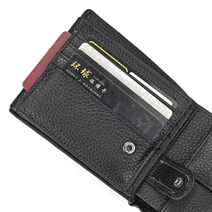 Detail view of black lychee grain leather wallet with multiple card slots and metal snap