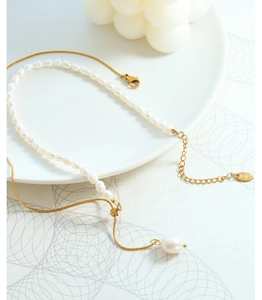 Detail of double-layer pearl and gold chain with lobster clasp and K18 tag
