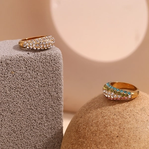 Detail of 18K gold plated stainless steel rings with sparkling crystals on stone pedestals
