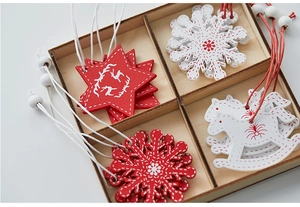 Detail view of red and white wooden Christmas ornaments set in a wooden organizer box